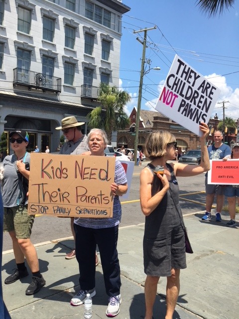 Sister Carol at immigration policy protest Immigration Protest gathering June 2018. Sister Carol holding sign saying Kids need their parents.